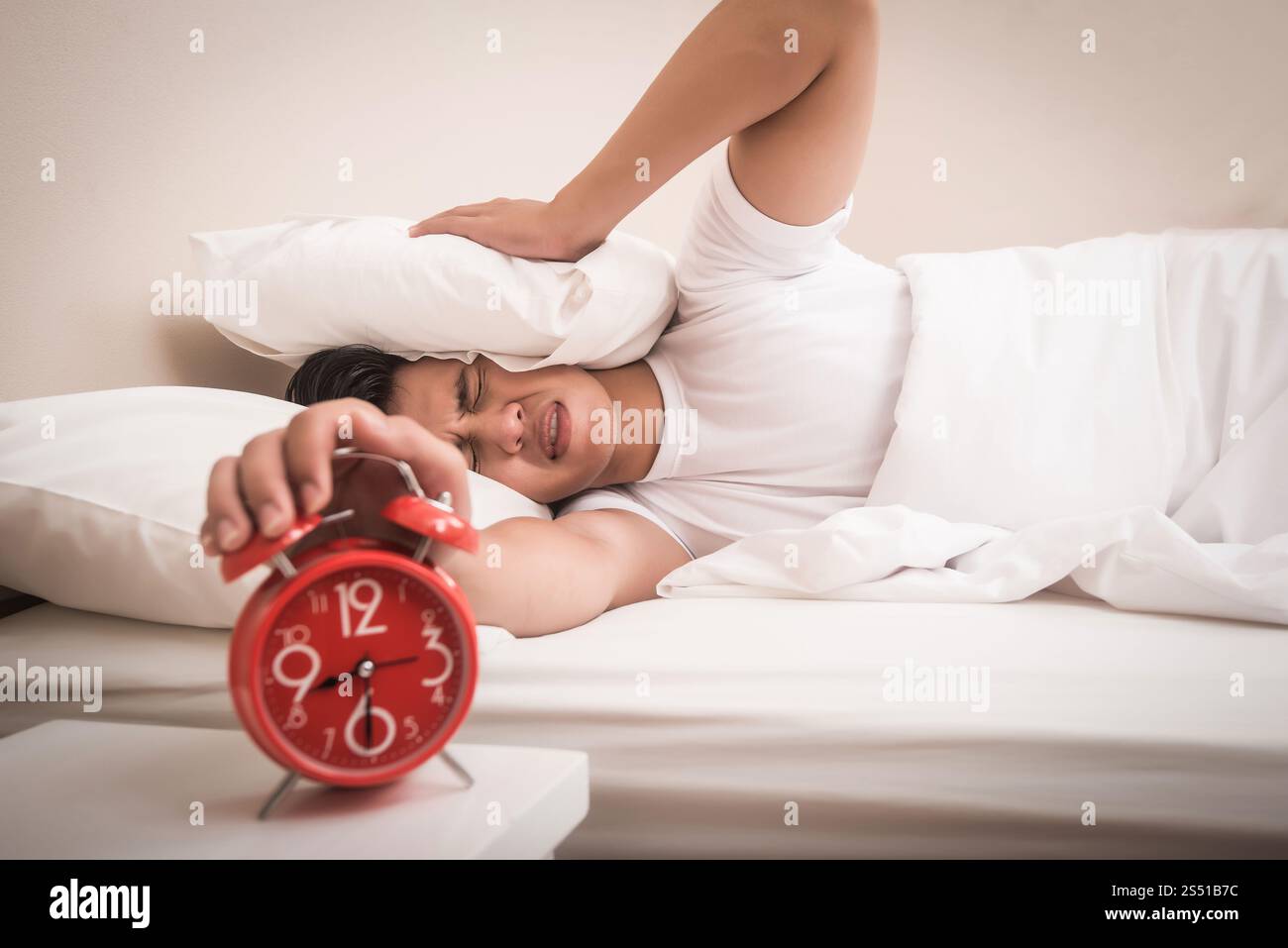 Man hand turns off the alarm clock waking up at morning . . Man hand turns off the alarm clock waking up at morning . Stock Photo