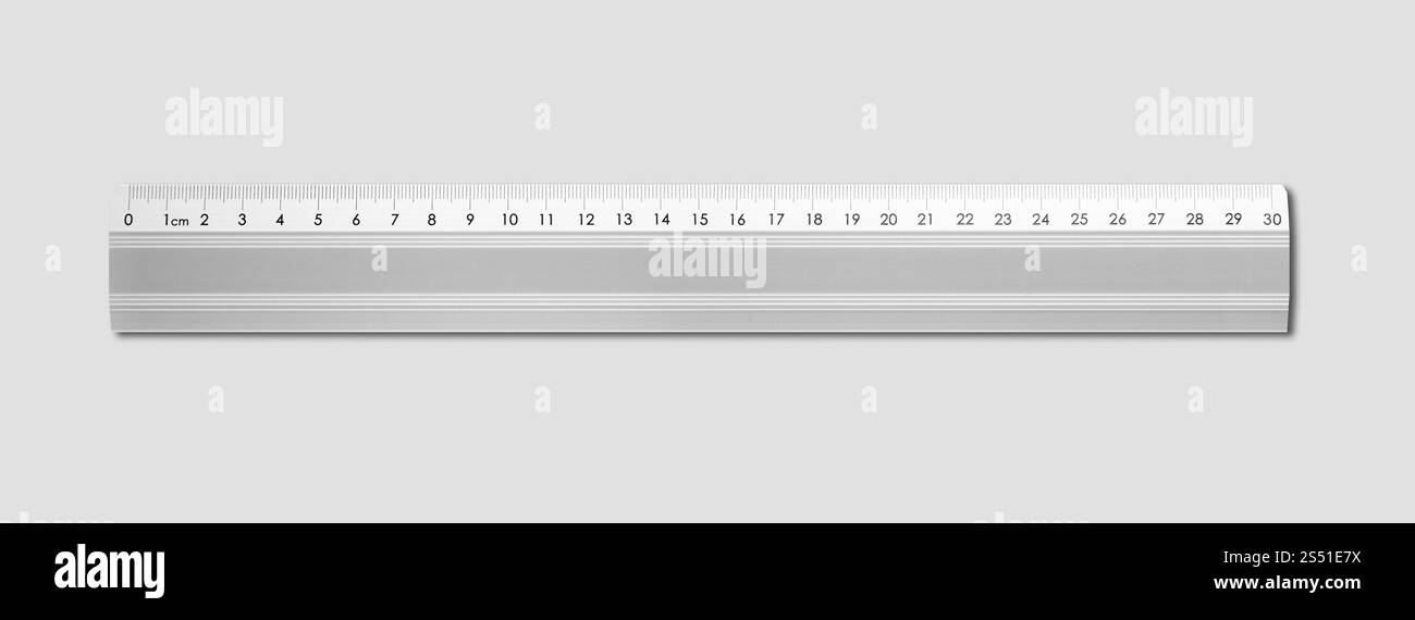 Steel metallic ruler isolated on grey background. Metal ruler isolated on grey background. Metal ruler isolated on grey background Stock Photo