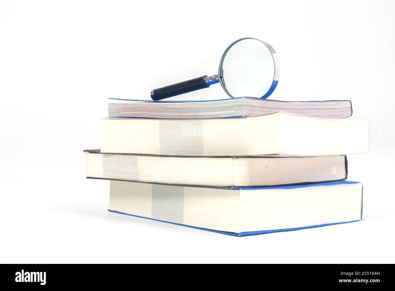 Pile of books with Magnifying glasson white background. Pile of books with Magnifying glasson white background Stock Photo