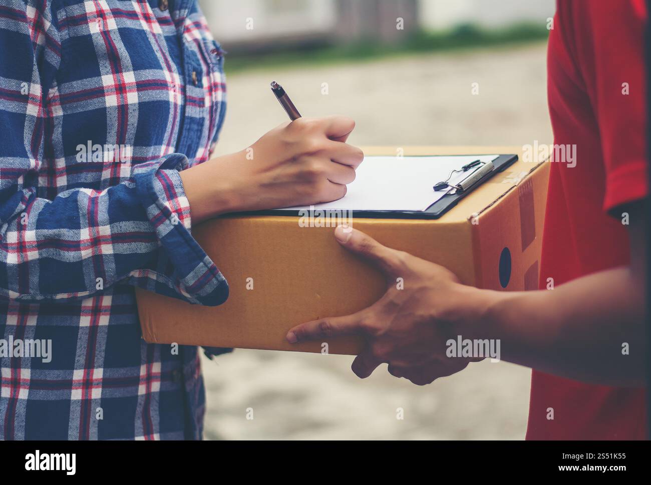 Young man Delivering Package to customer at home. Delivery Stock Photo