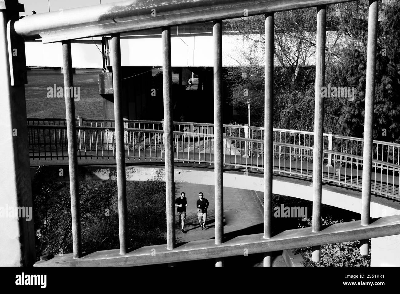 Urban Walkway with Metal Bars and Pedestrians in Monochromatic Focus, Portland, Oregon Stock Photo
