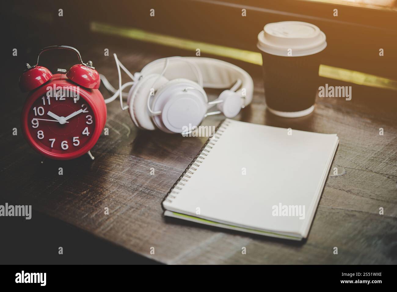 Paper cup of coffee,notebook and Red alarm clock with headphone . Paper ...
