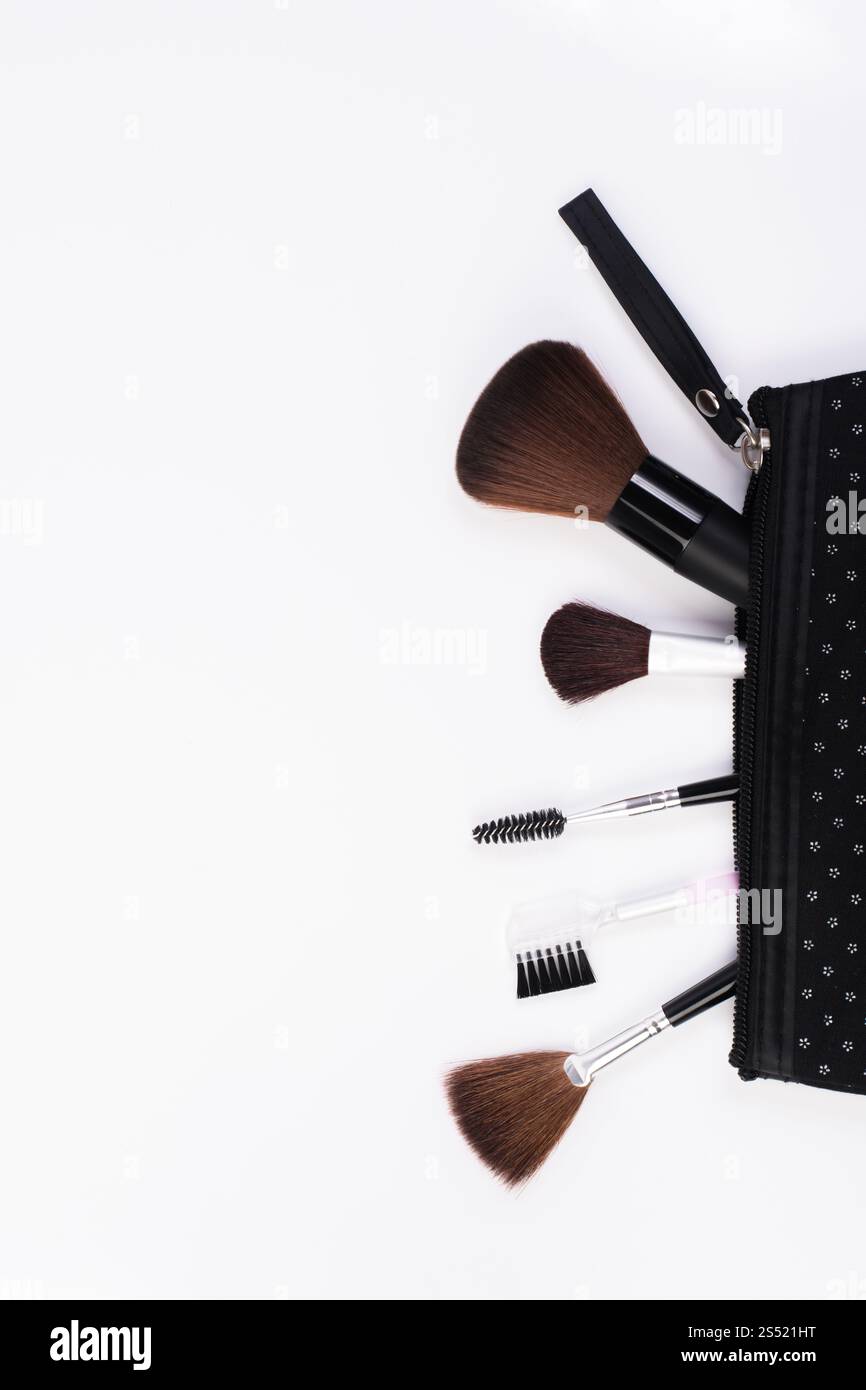 Makeup Brushes in comestic bag isolated on white background. Stock Photo