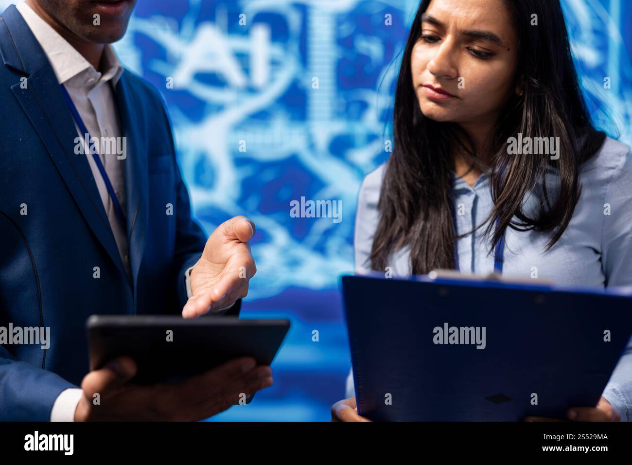 Admins use AI machine learning to extract information from complex data on tablet. Employees in workspace use artificial intelligence technology on device, comparing parameters, close up Stock Photo