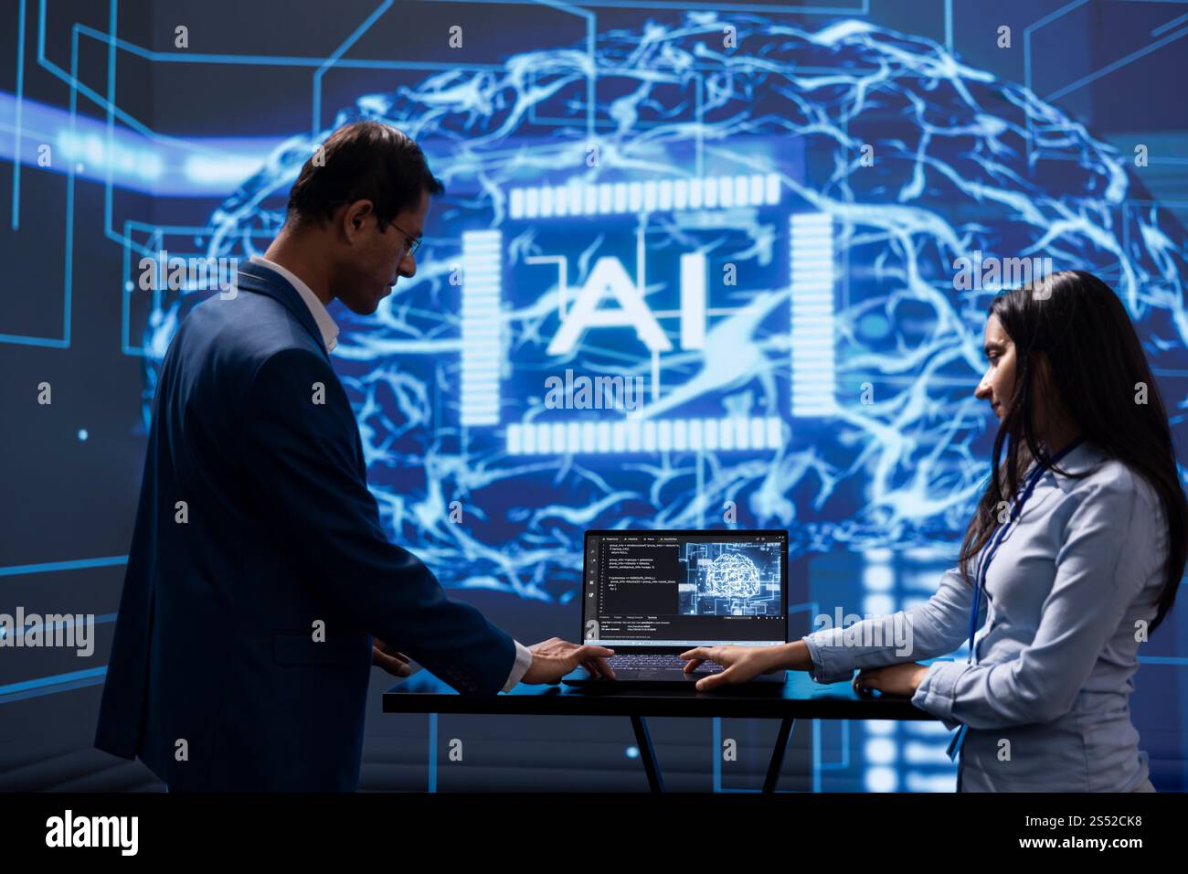 Engineer and coworker use AI cognitive computing to extract information from complex data on laptop. IT staff members using artificial intelligence on notebook to accelerate complex calculations Stock Photo