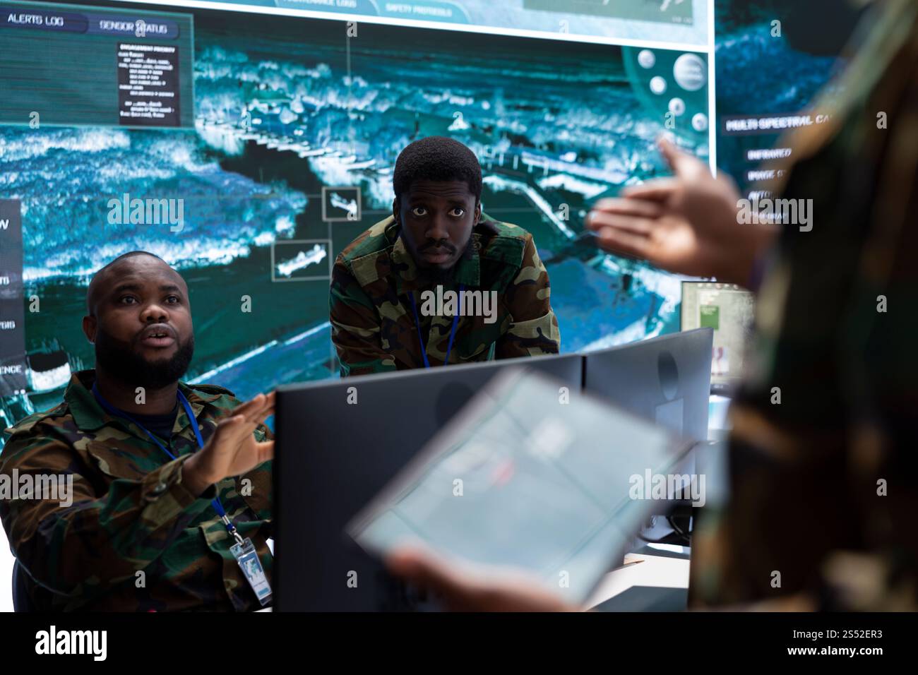 Army professionals in command post overseeing satellite data and real ...