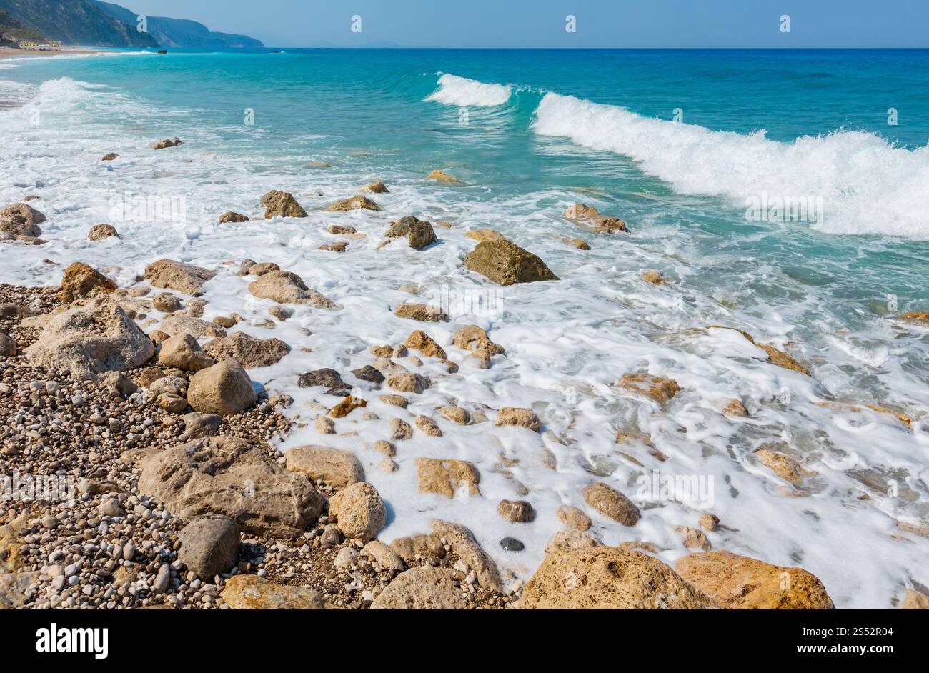 Beautiful summer Lefkada coast stony beach, Greece, Ionian Sea. People unrecognizable. Stock Photo