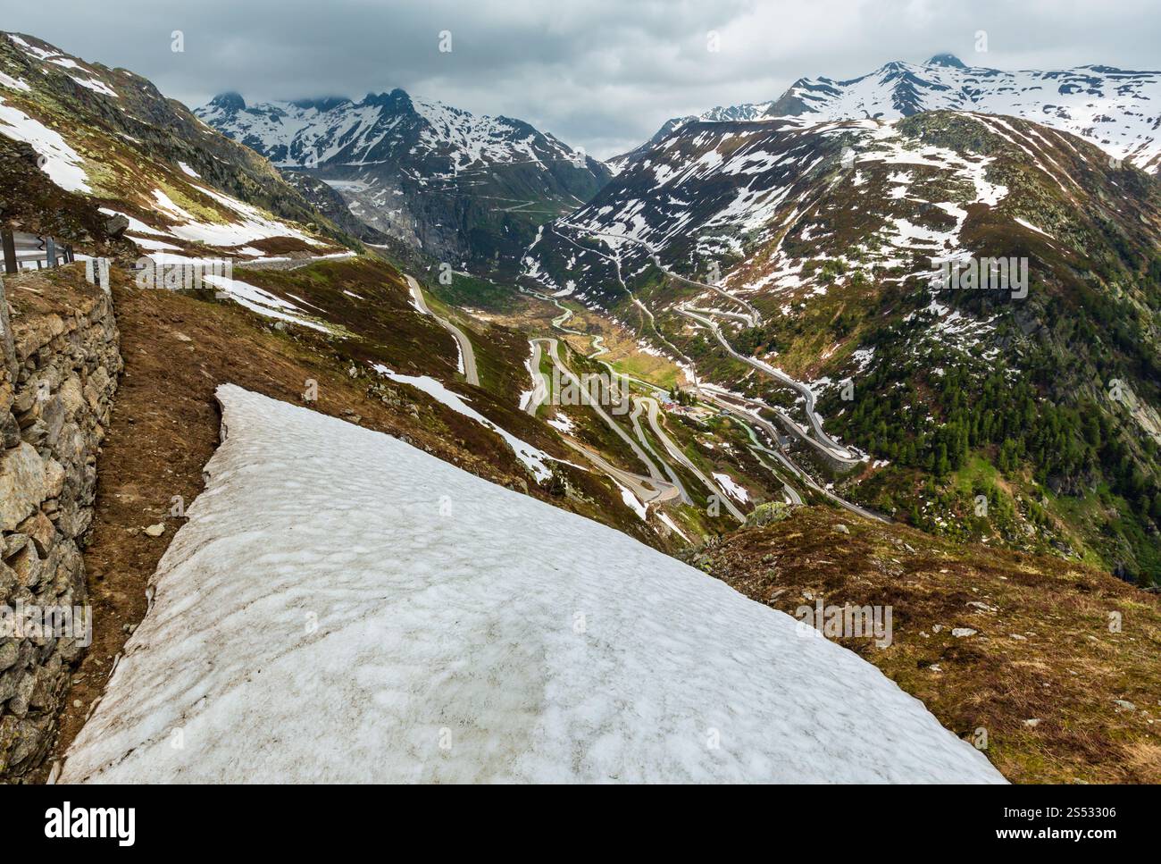 Summer mountain landscape with serpentine alpine roads (Grimsel Pass, Switzerland) Stock Photo
