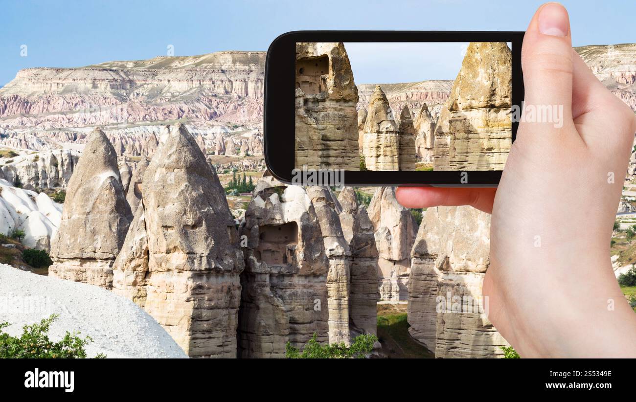 Cappadocia Rocks travel concept - tourist photographs of old fairy chimney rocks in ...
