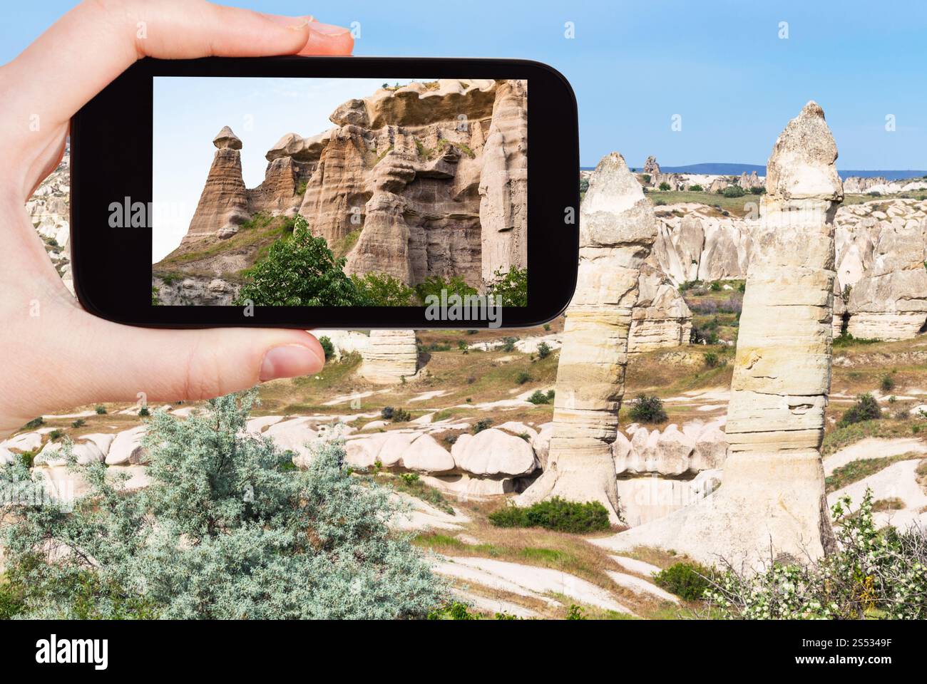 Cappadocia Rocks travel concept - tourist photographs of landscape with old fairy ...