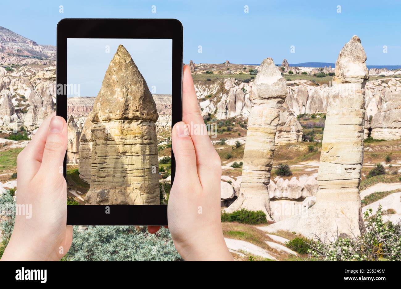 Cappadocia Rocks travel concept - tourist photographs of landscape with old fairy ...