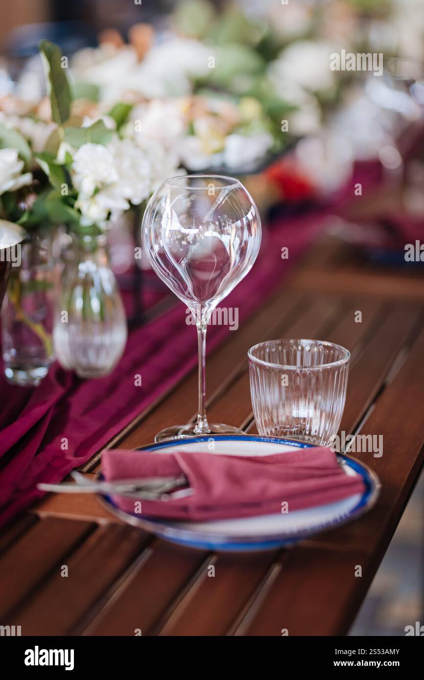 Elegant wine glass and water glass on a rustic table, perfect for fine ...