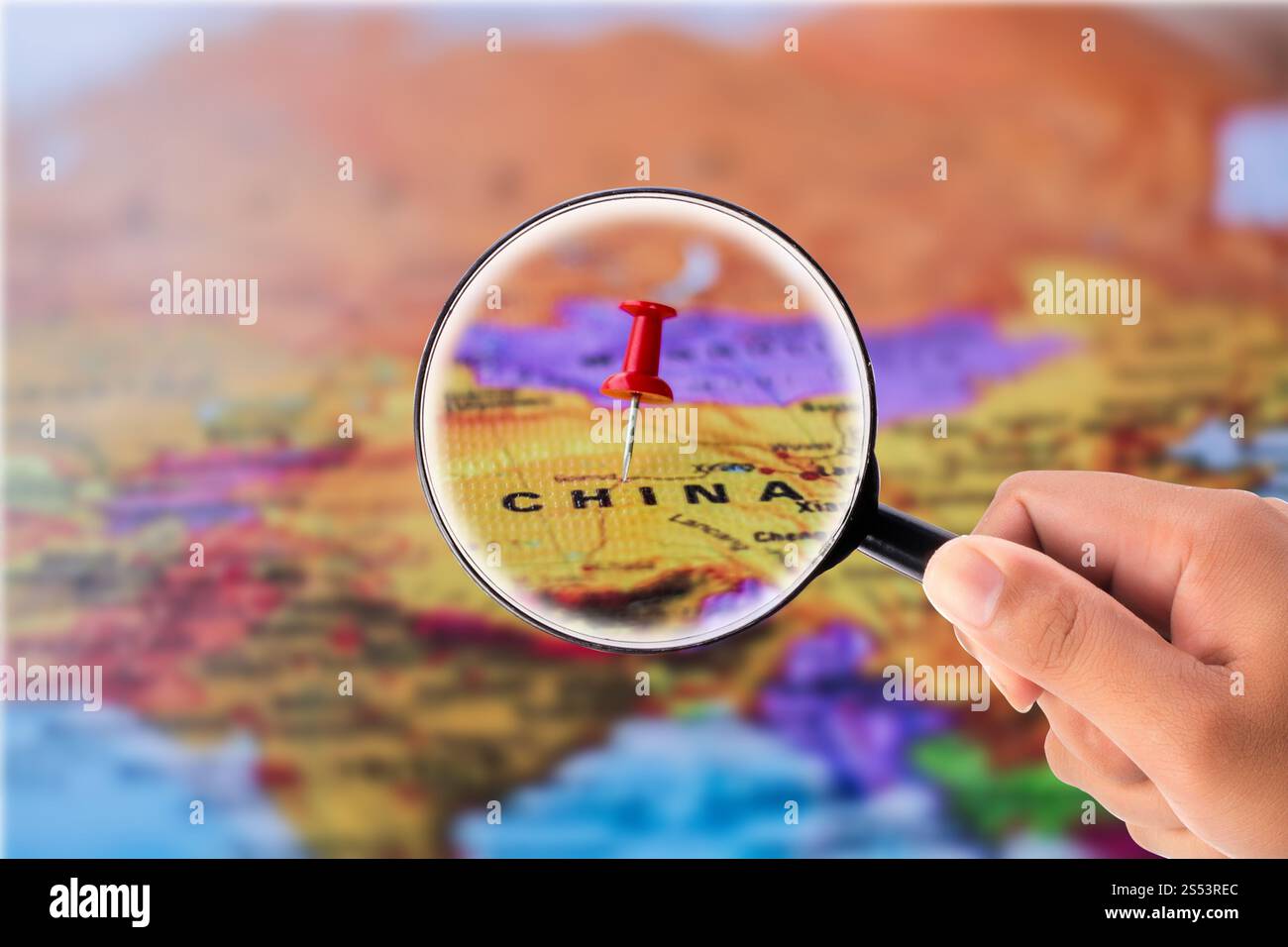 Hand holding magnifying glass Stock Photo