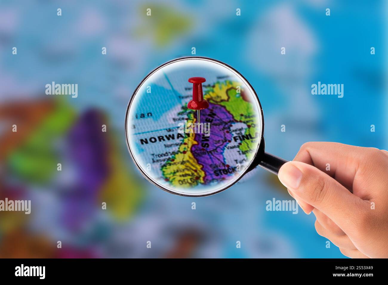 Hand holding magnifying glass Stock Photo