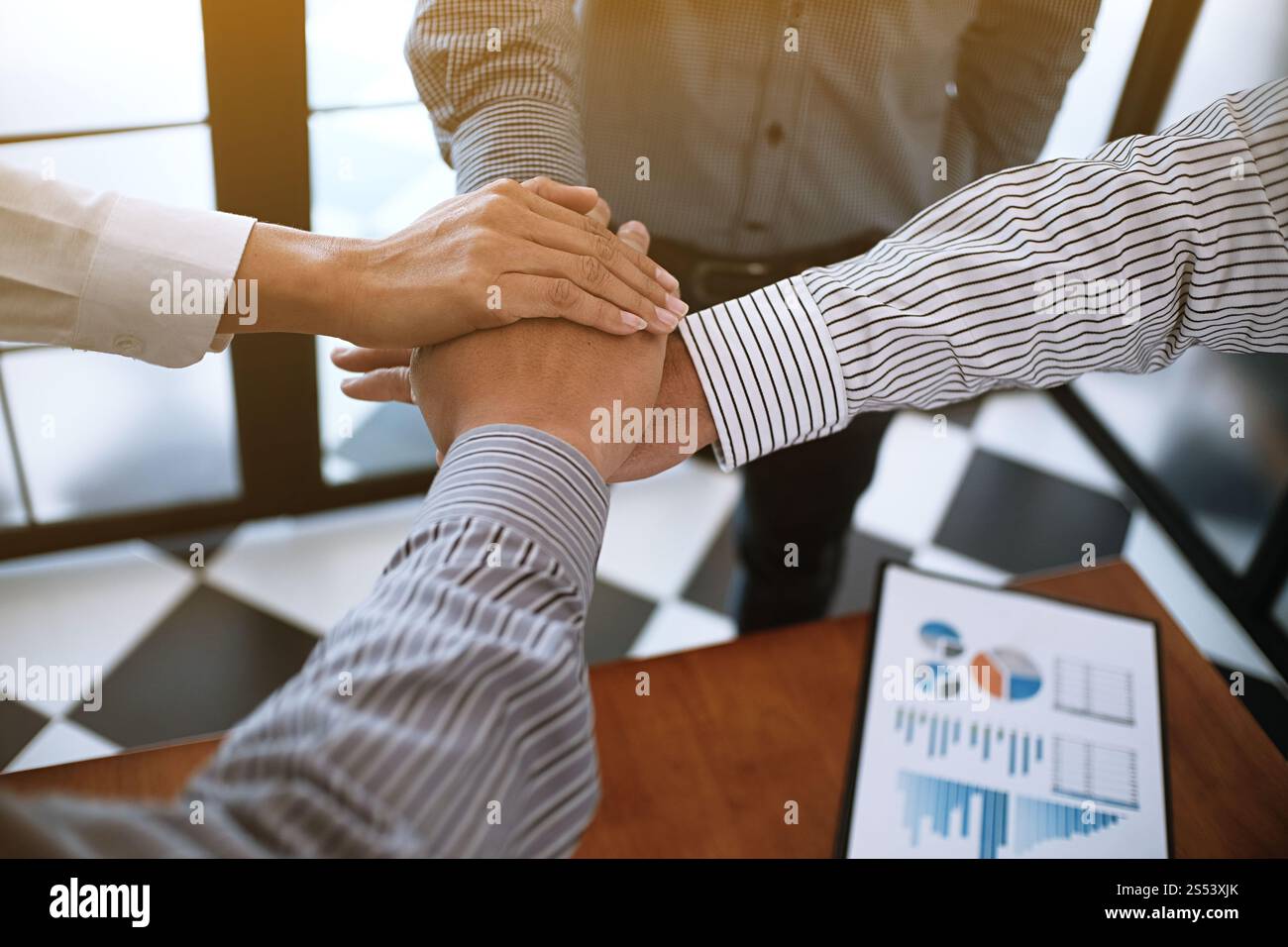 Business partnership putting hands together Stock Photo