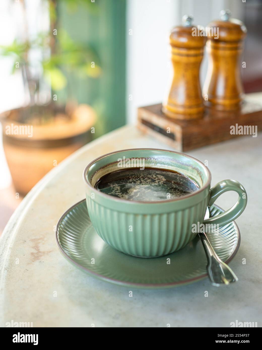 Cup of hot black coffee on table. Stock Photo
