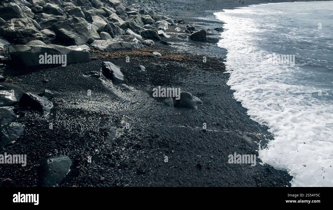 Landscape of black rocks and cliffs on volcanic sea beach. Landscape of ...