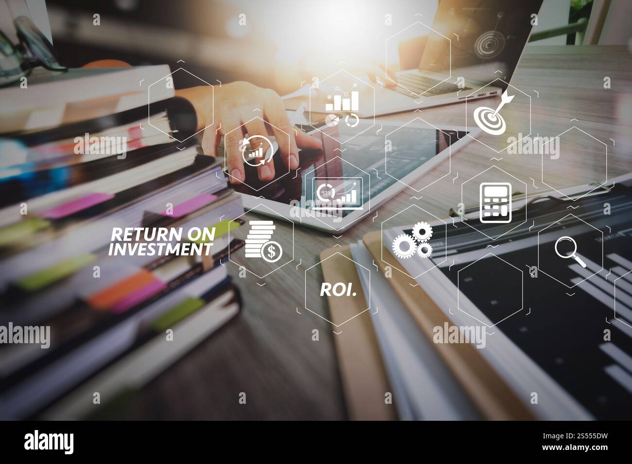 ROI Return on Investment indicator in virtual dashboard for improving business. designer hand working with digital tablet and laptop computer and Stock Photo