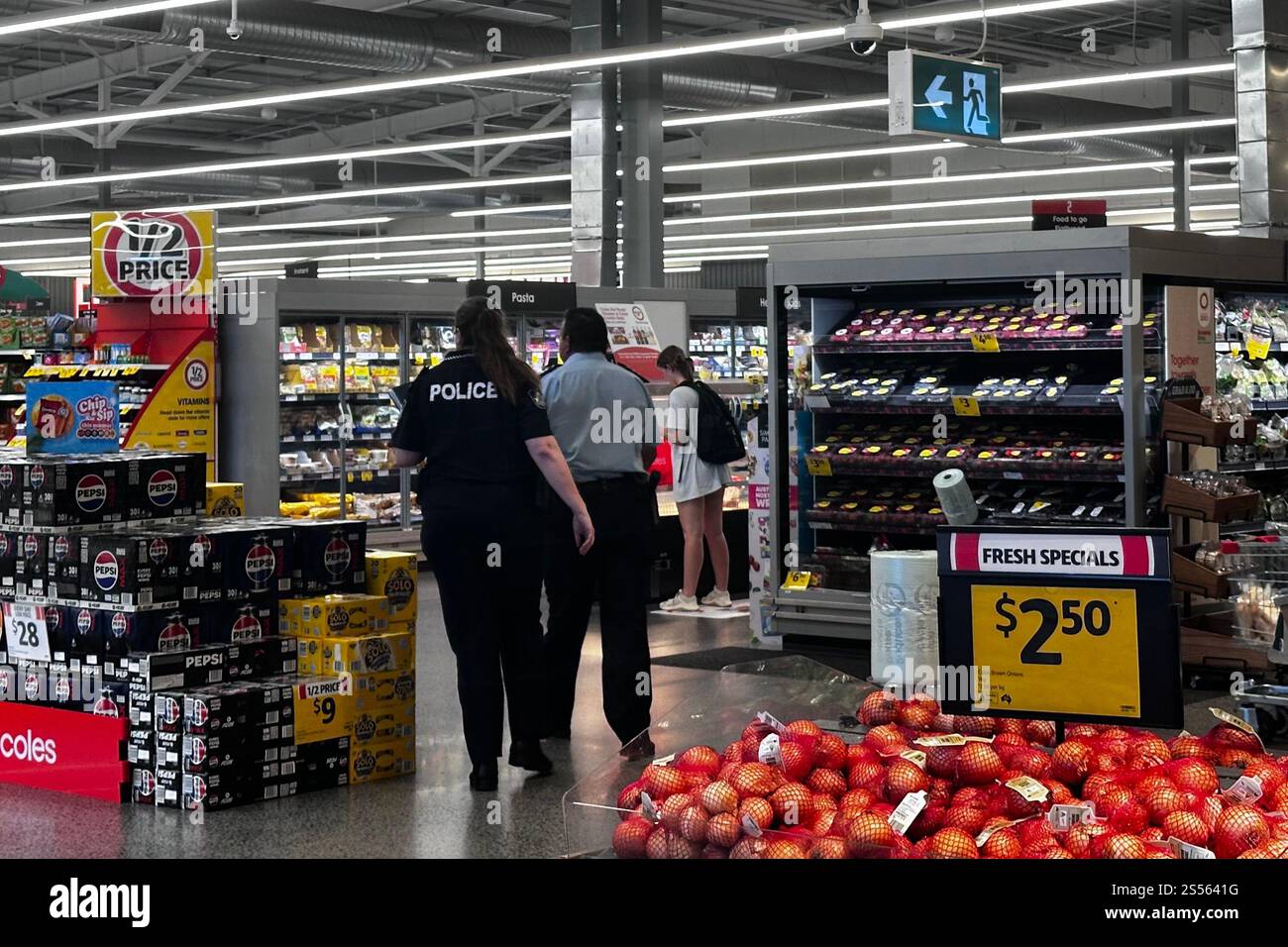 Police enter the Coles in Yamanto Central shopping centre near Ipswich