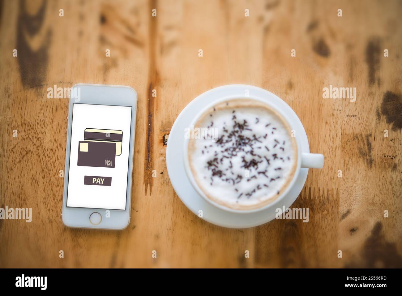 Online purchase with a credit card on smartphone screen while chilling at cafe. Stock Photo