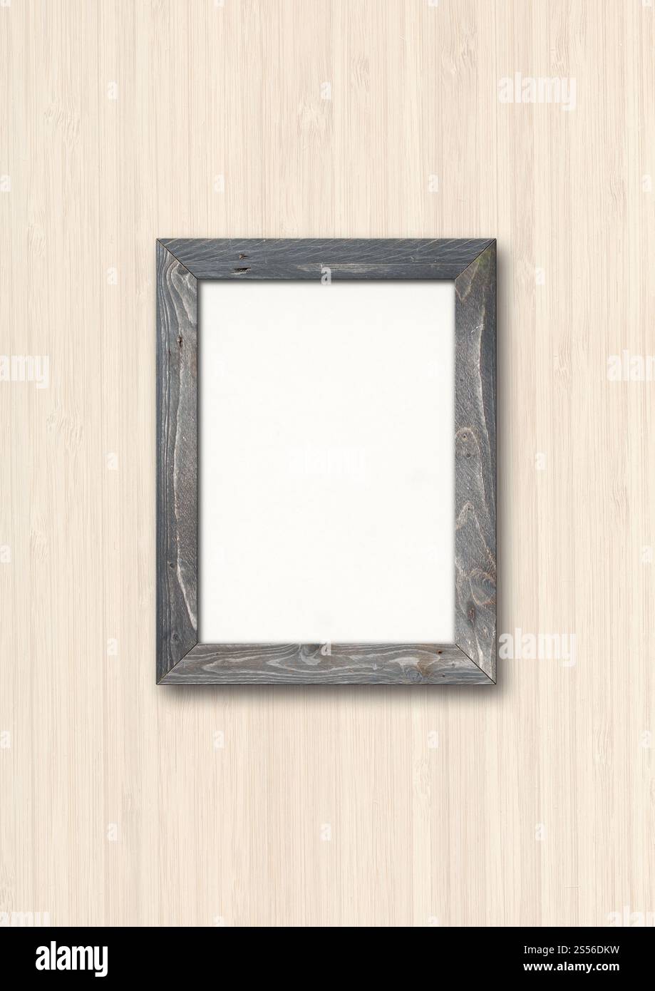 Old grey rustic wooden picture frame hanging on a wood wall. Blank ...