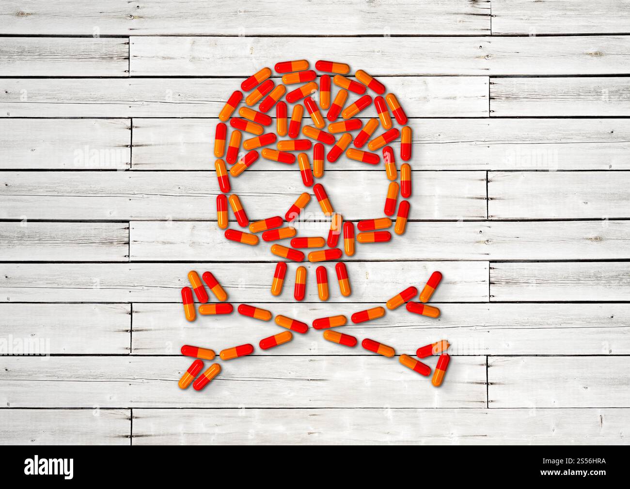 Skull made of orange capsule pills isolated on white wooden background. 3D illustration Stock Photo