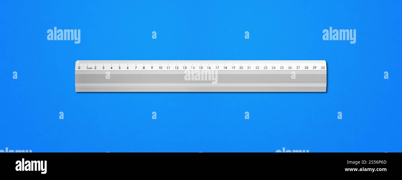 Steel metallic ruler isolated on blue background. Metal ruler isolated ...
