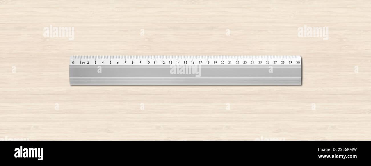 Steel metallic ruler isolated on white wooden background. Metal ruler ...