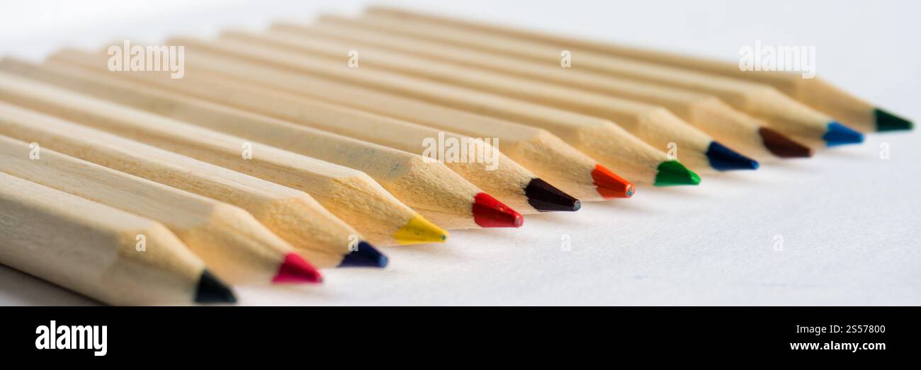 Kid education concept. Color pencils on white paper background. copy space for text Stock Photo