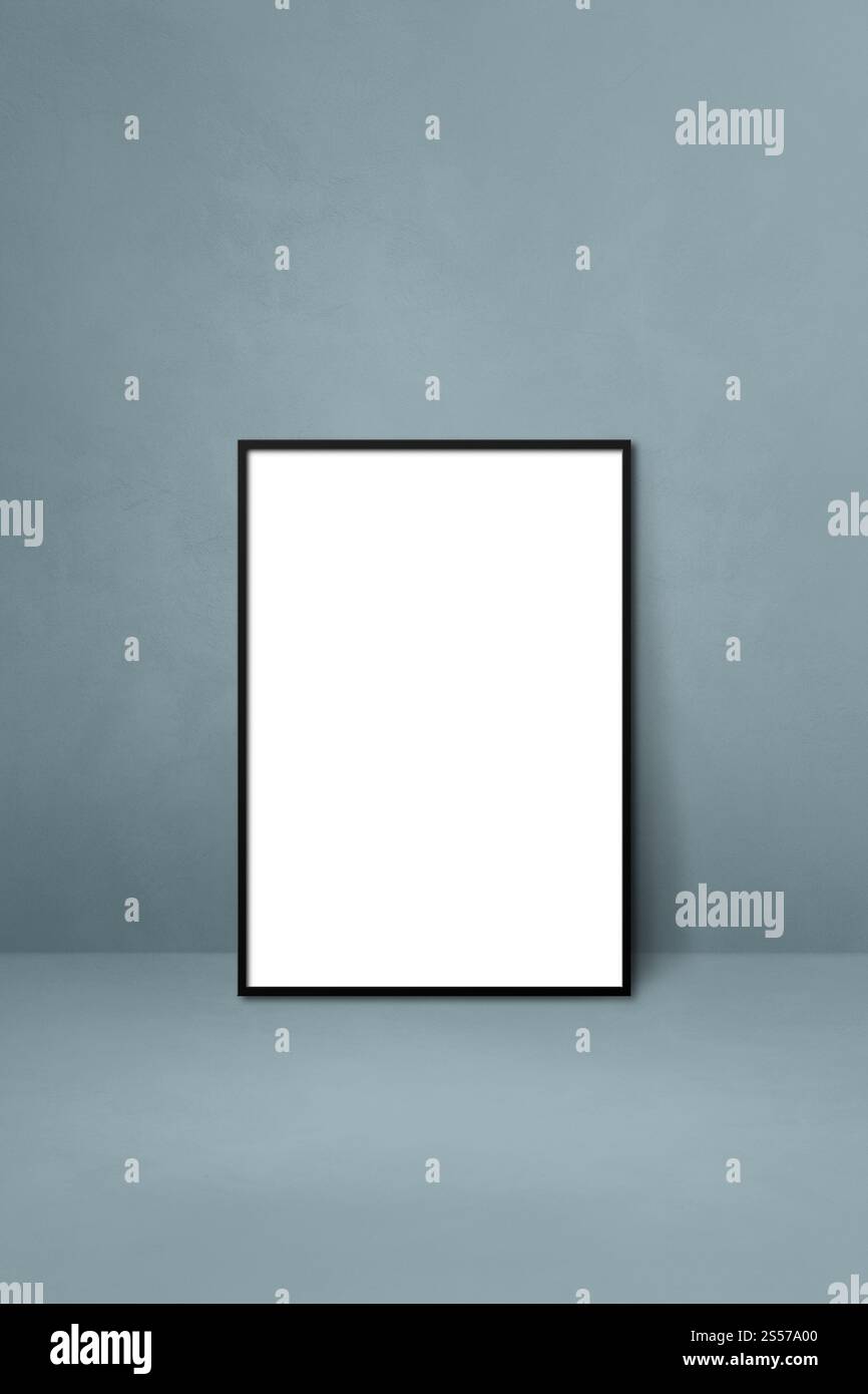 Black picture frame leaning on a grey wall. Blank mockup template ...