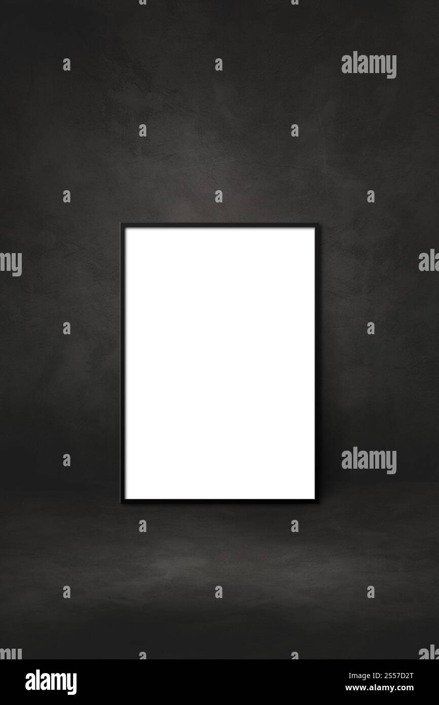 Blank picture frame leaning on a black wall. Presentation mockup ...