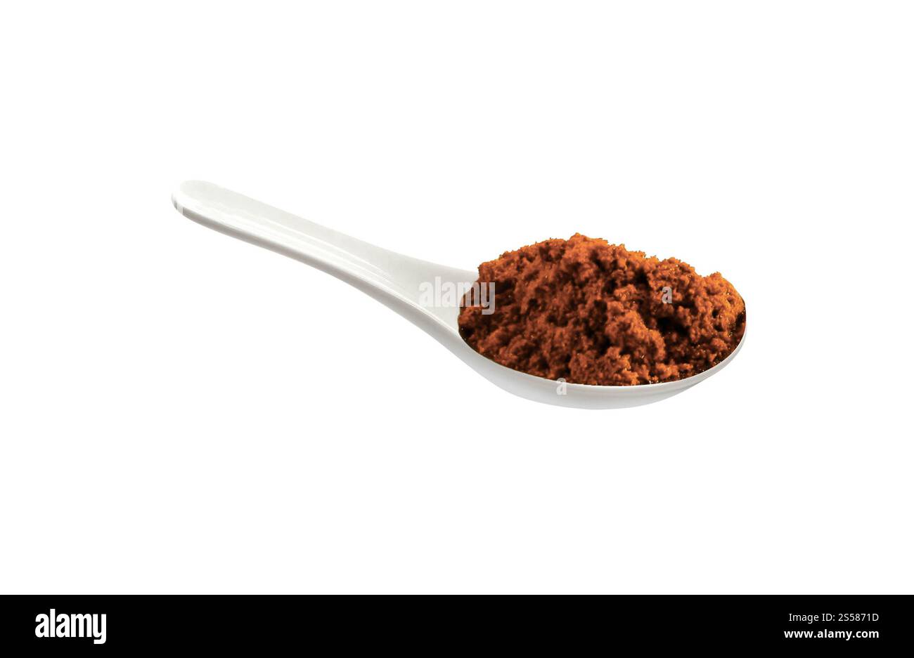 powder spice on a white porcelain spoon Stock Photo