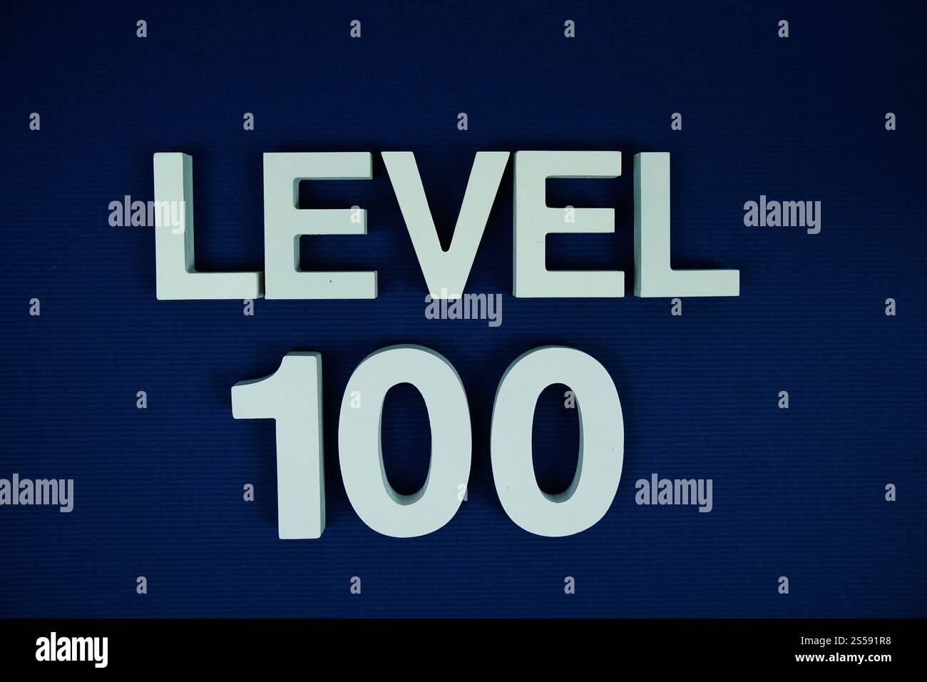 Level 100 Level One hundred alphabet letters on navy blue background ...