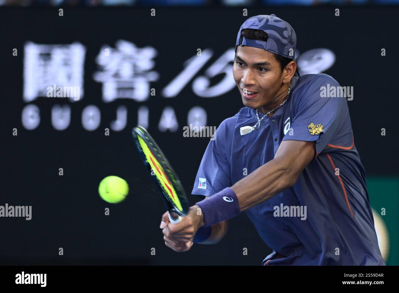 Kasidit Samrej of Thailand returns during his round 1 match against