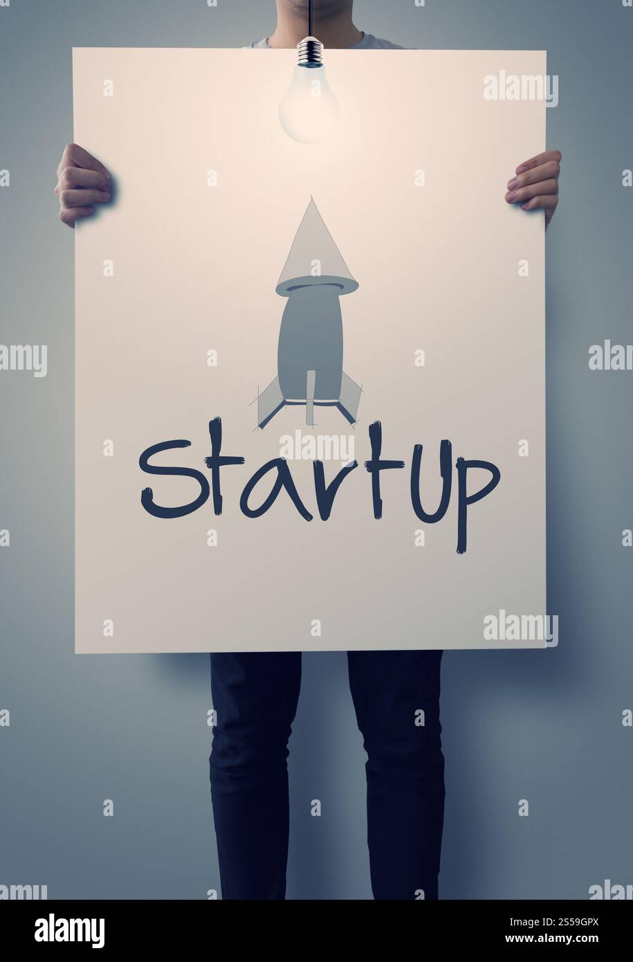 businessman hand showing poster of start up icon as concept Stock Photo