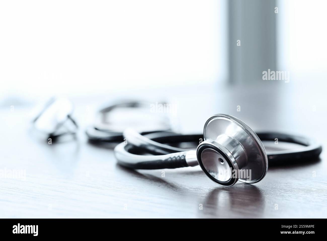 Stethoscope with digital tablet computer on wooden table and background Stock Photo