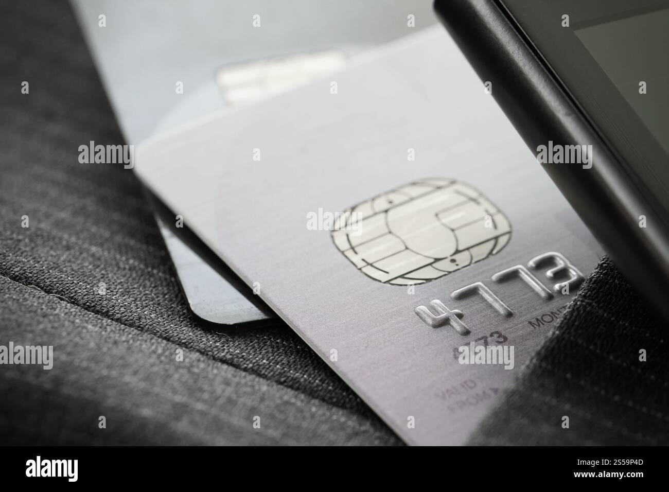 Credit cards in very shallow focus with gray suit background Stock Photo