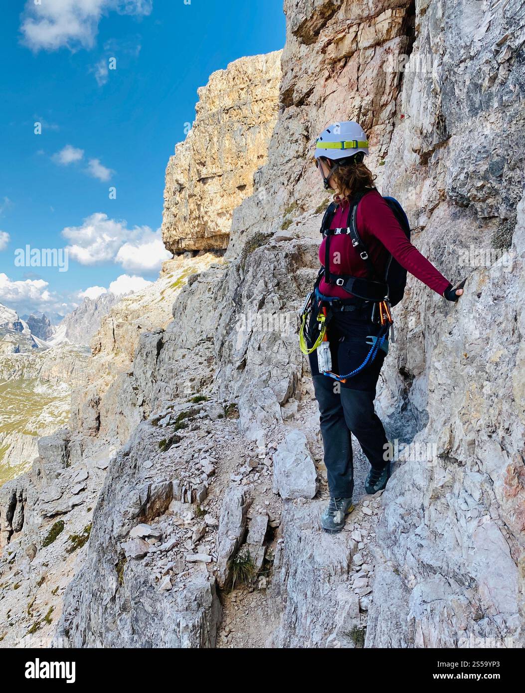 A woman climbing a mountain in Dolomites in Italy - Smartphone Captured Stock Image