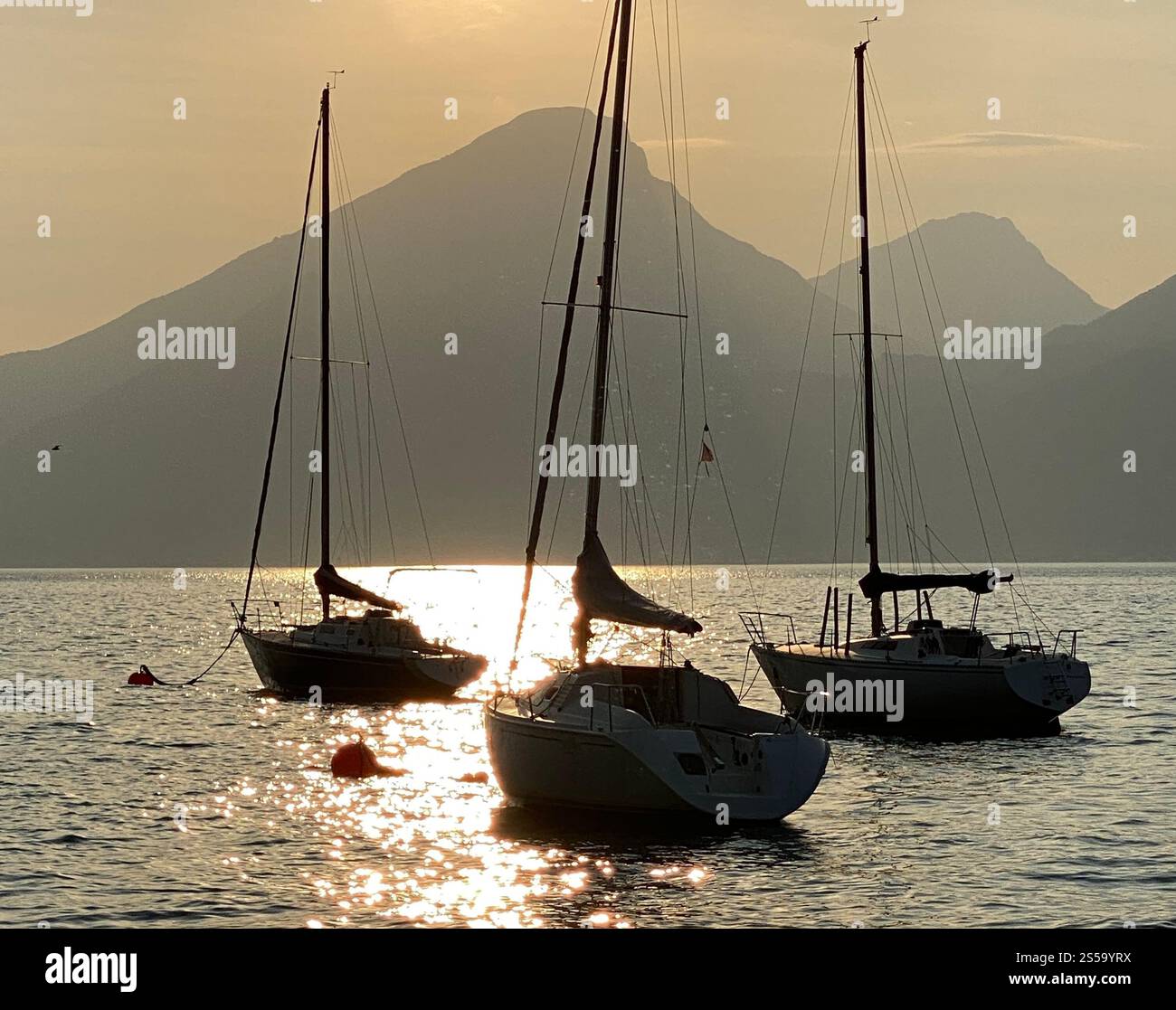 Three boats floating on Lake Garda in Italy - Smartphone Captured Stock Image