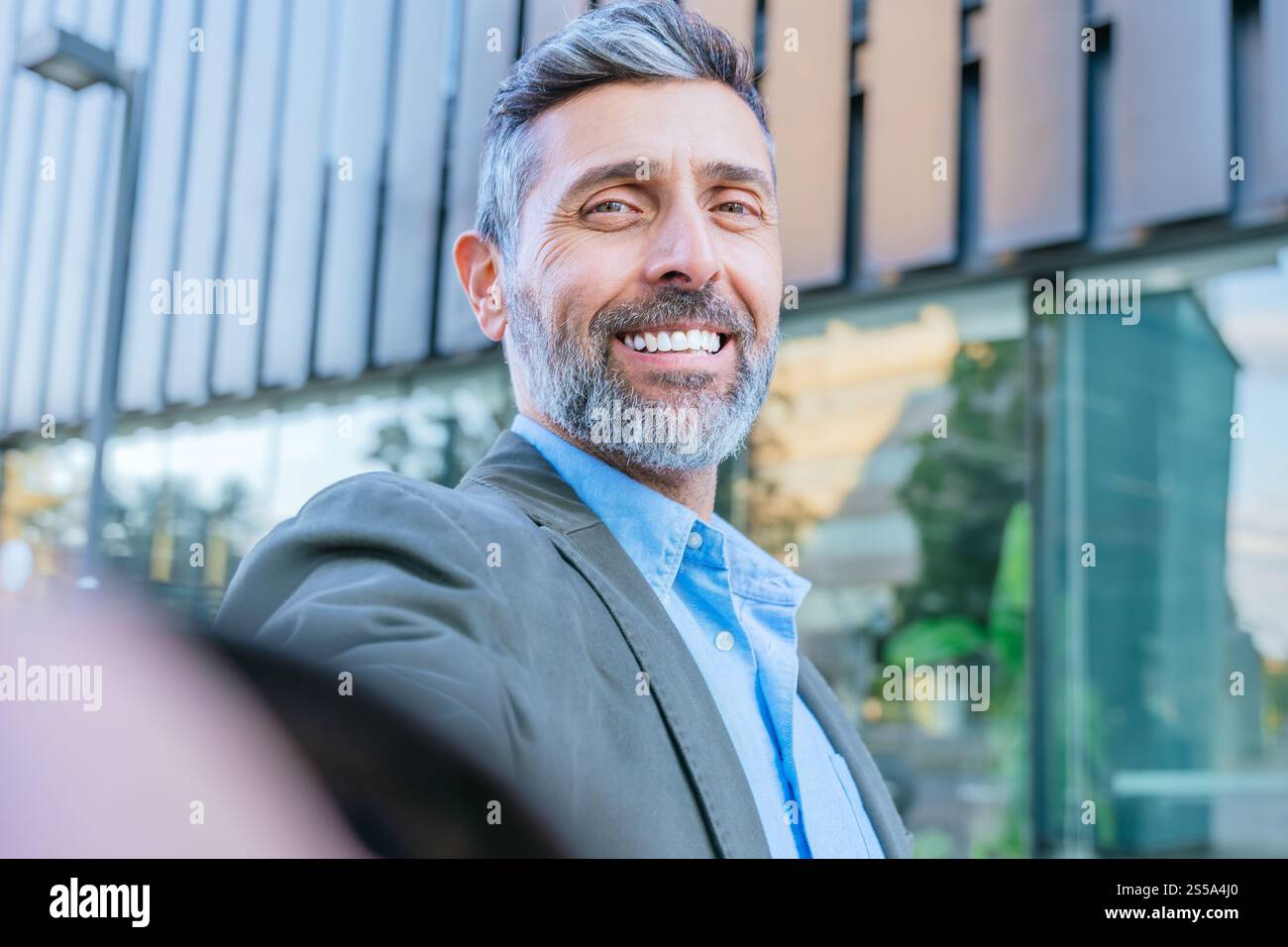 Confident Businessman Smiling Outdoors in Urban Setting Stock Photo - Alamy