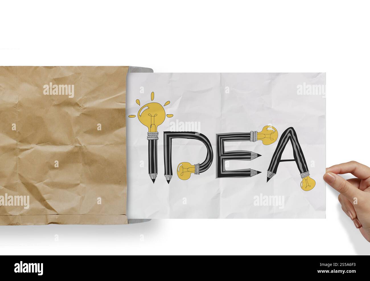 hand pulling crumpled paper from envelope with design word IDEA as concept Stock Photo