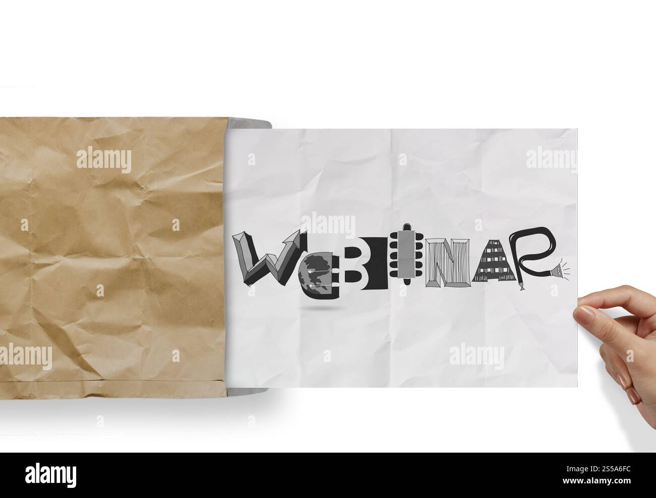 hand pulling crumpled paper from envelope with design word WEBINAR as concept Stock Photo