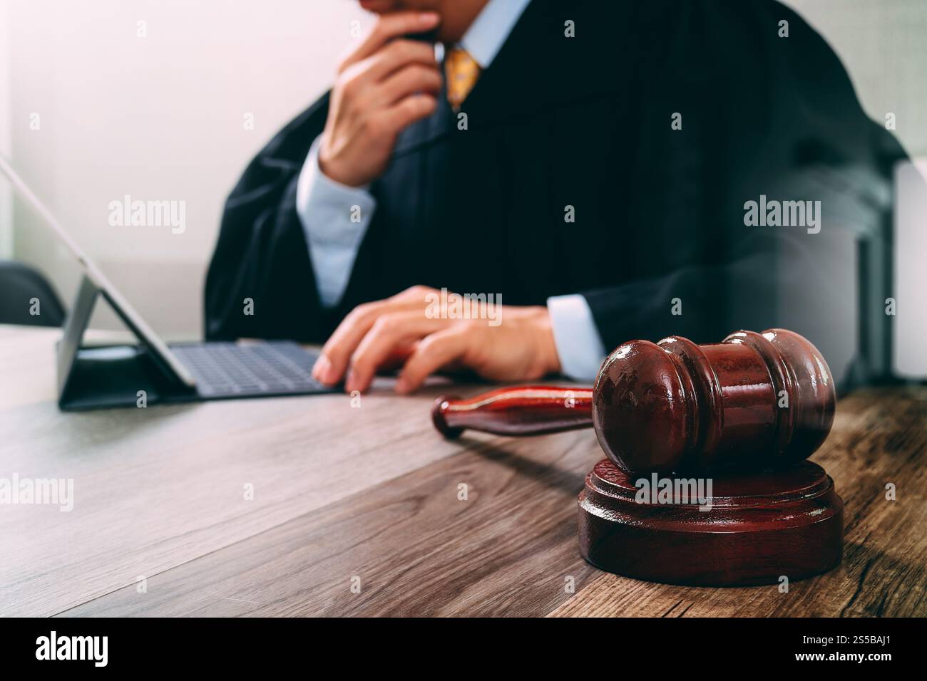 Justice Tablet justice and law concept.Male judge in a courtroom with the gavel ...