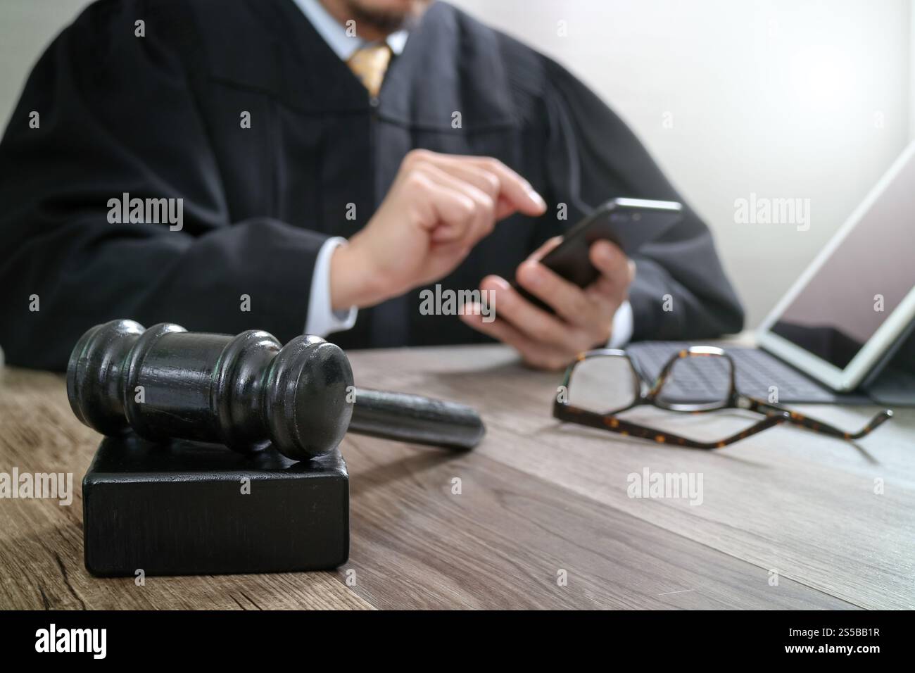 Justice Tablet justice and law concept.Male judge in a courtroom with the gavel ...