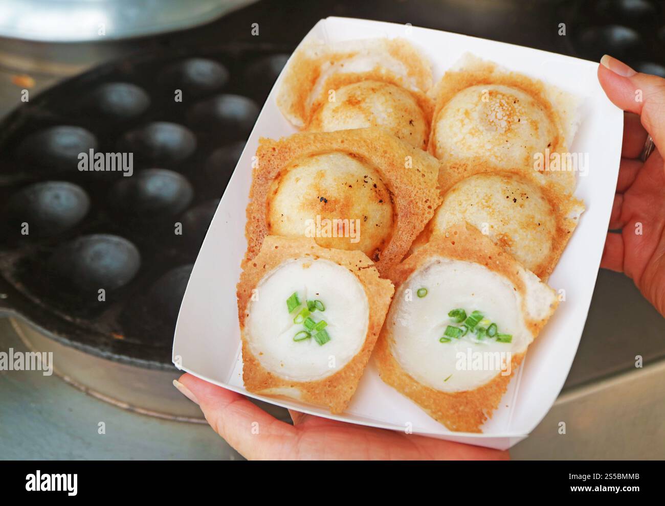 Sweet and fragrant Thai coconut milk pancakes called Kanom Krok, one of the popular street food in Thailand Stock Photo