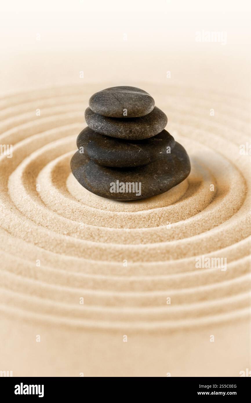 Black stones pile in the sand. Zen japanese garden background scene ...