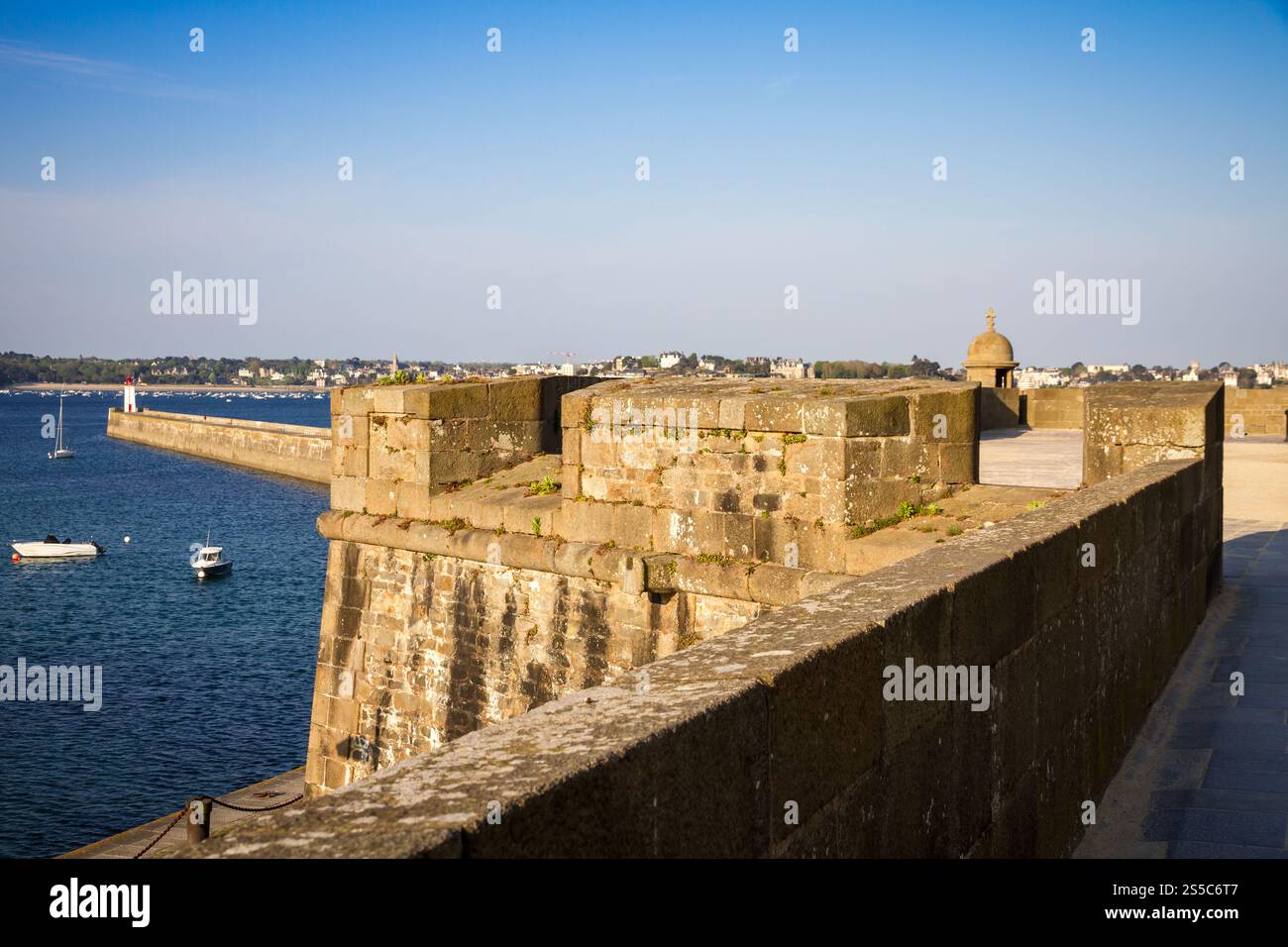Saint-Malo lighthouse, sea and pier view from the city fortifications, Brittany, France. Saint-Malo lighthouse and pier view from the city Stock Photo