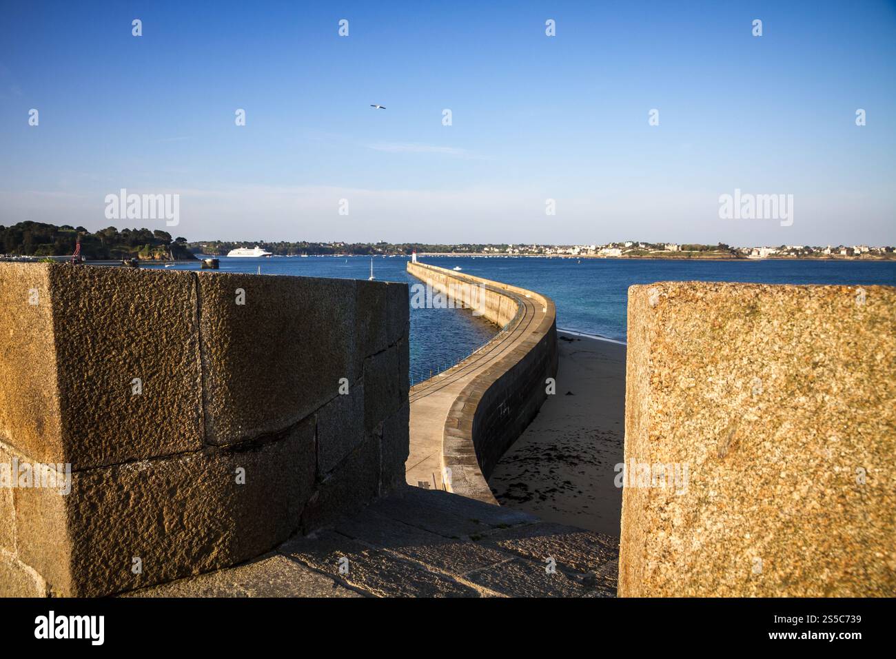 Saint-Malo lighthouse, sea and pier view from the city fortifications, Brittany, France. Saint-Malo lighthouse and pier view from the city Stock Photo