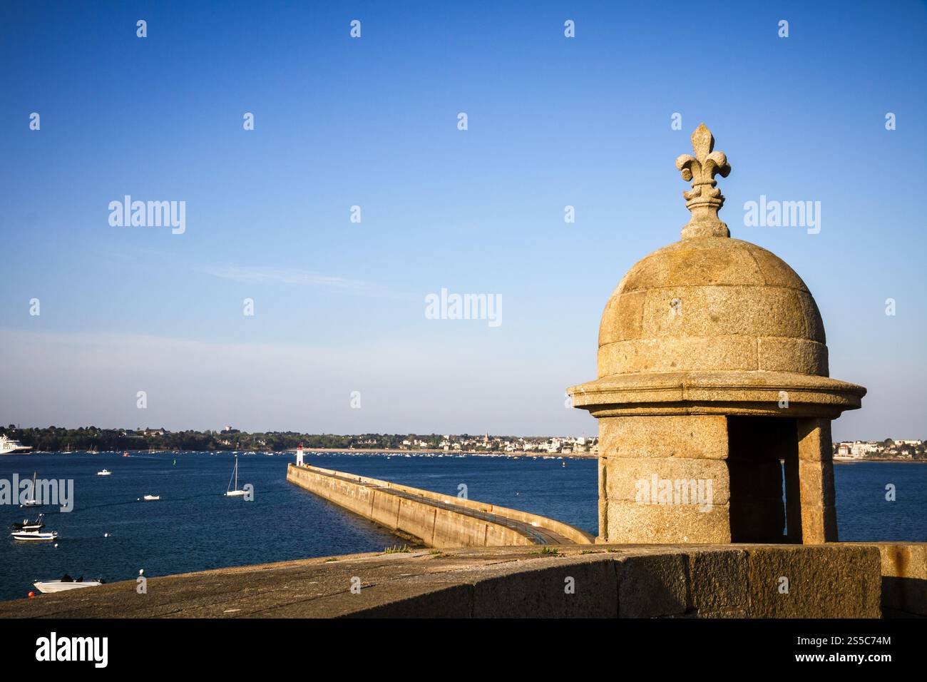 Saint-Malo lighthouse, sea and pier view from the city fortifications, Brittany, France. Saint-Malo lighthouse and pier view from the city Stock Photo