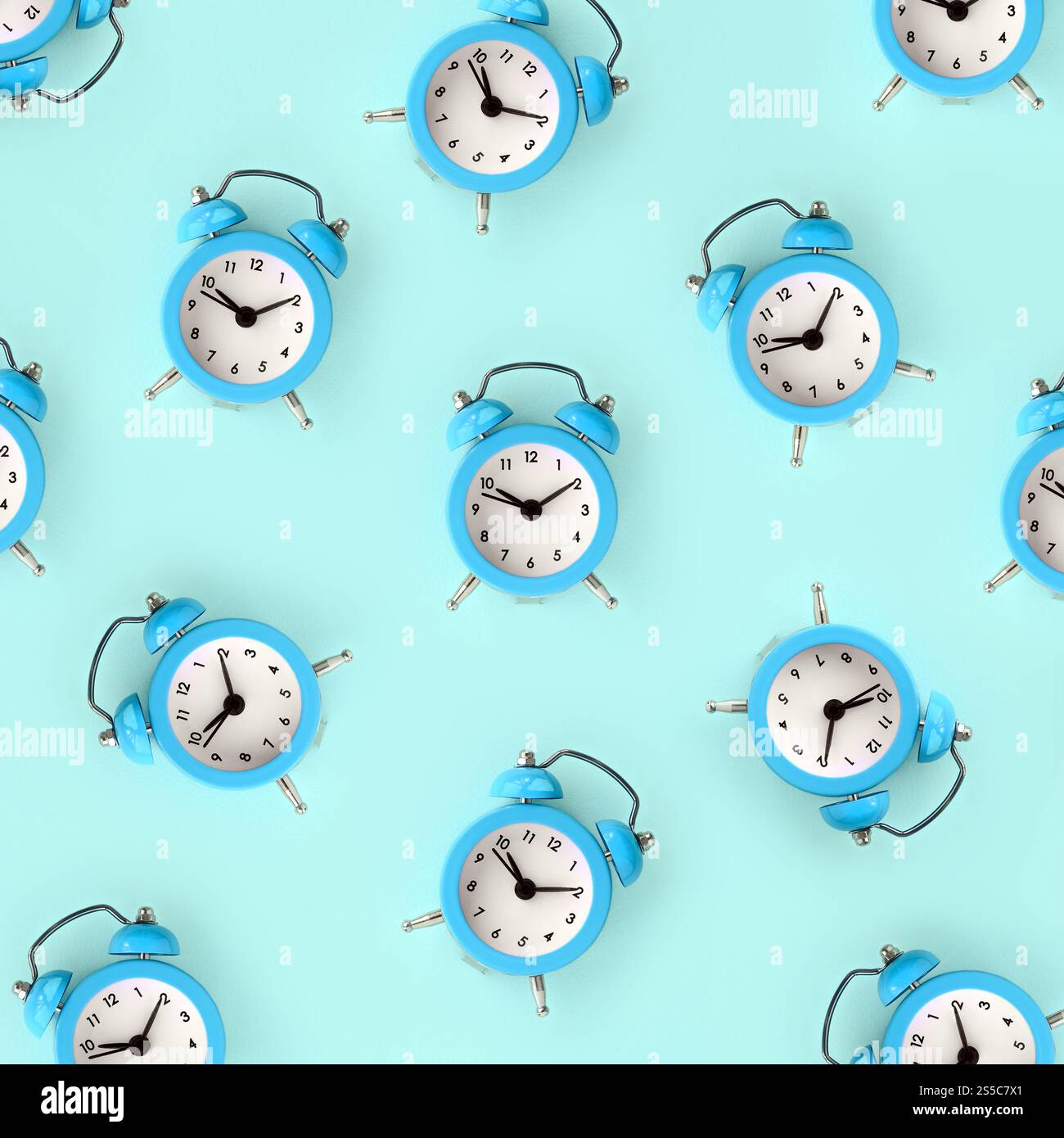 Flat lay retro beautiful new alarm clock on blue color background ...